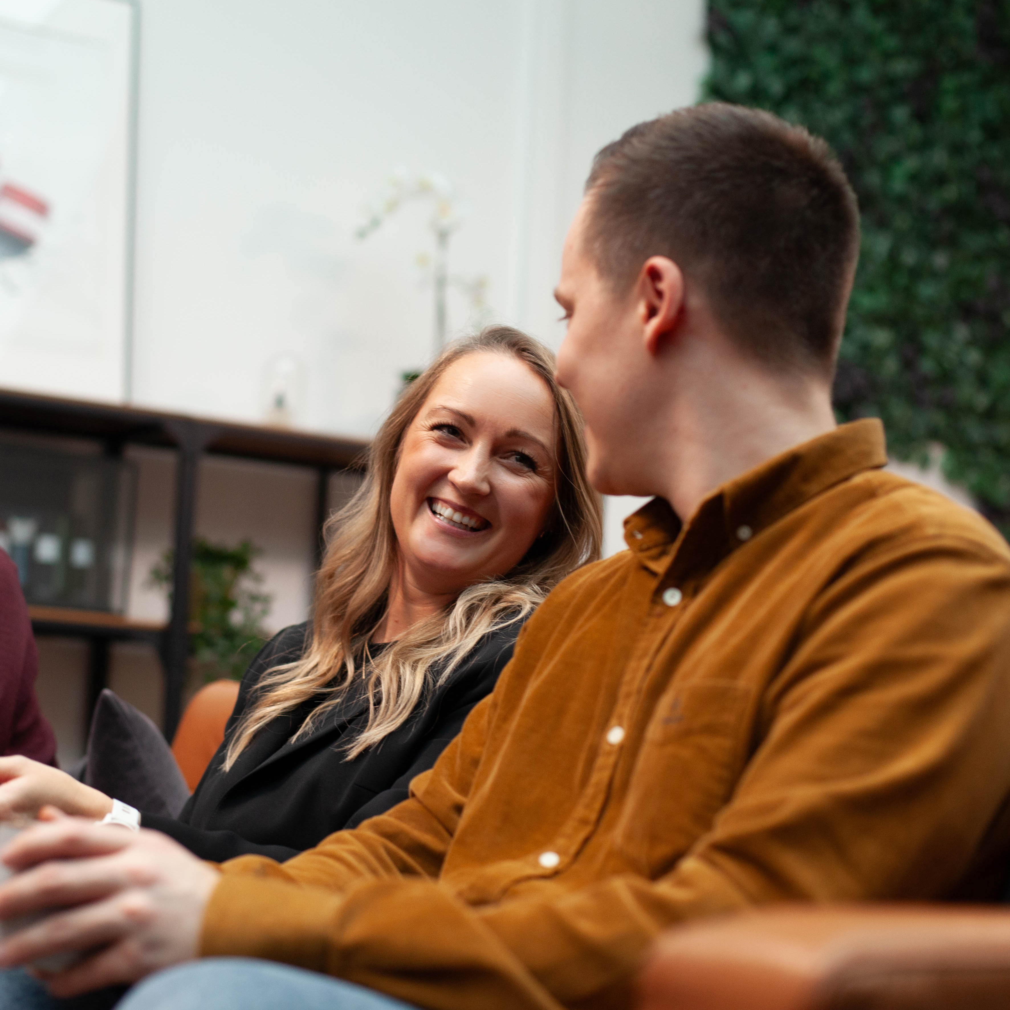 Employees in conversation in an open and welcoming work environment