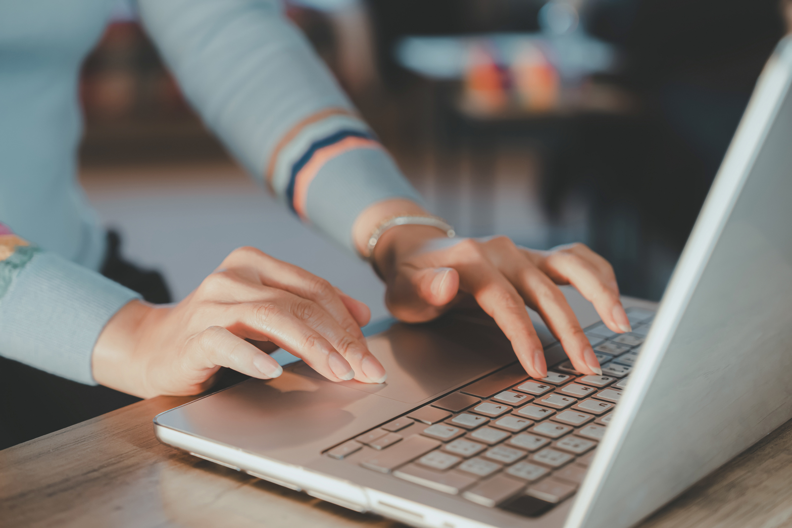 Woman without face writing on laptop