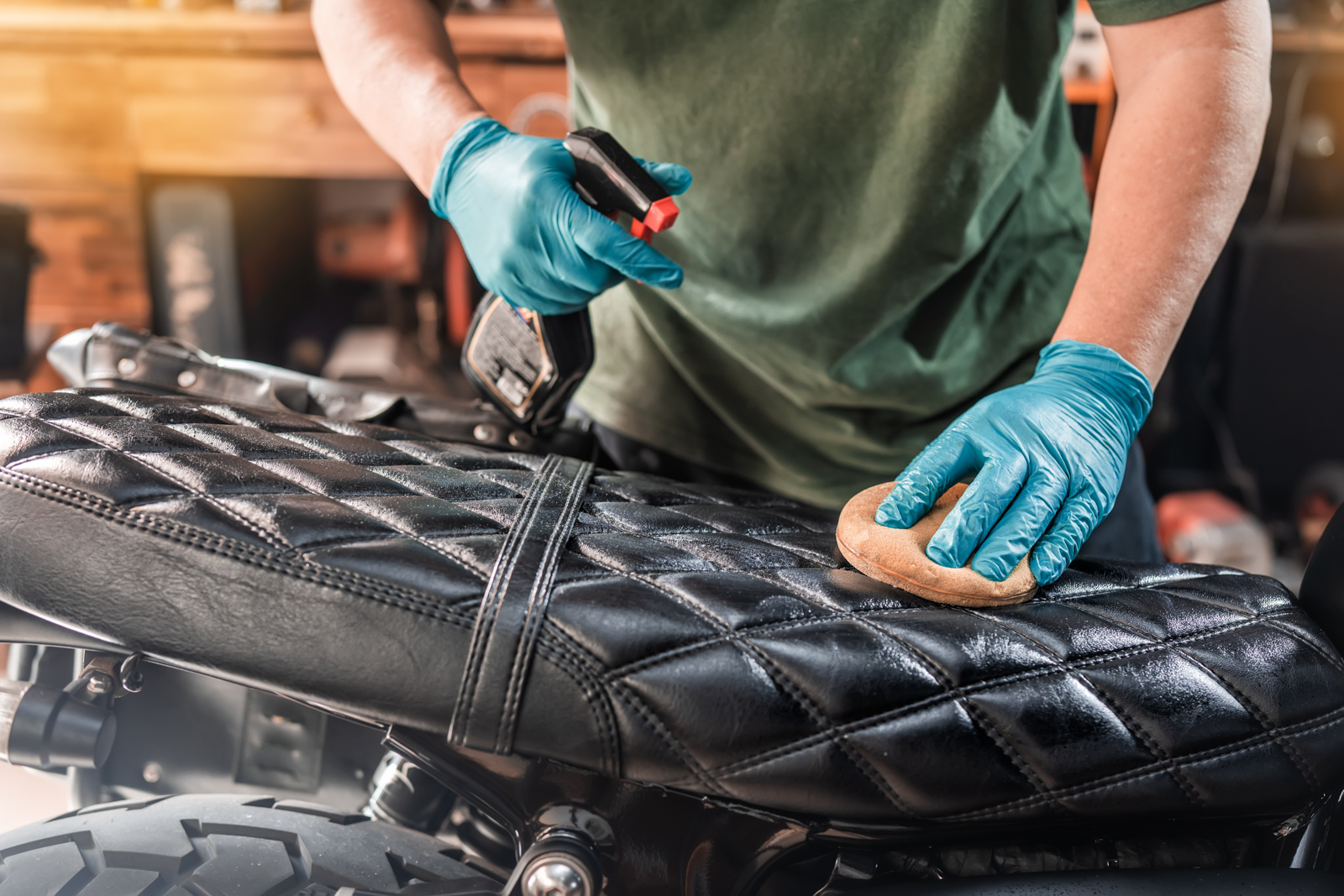 Man applying leahter care solution to a four-wheeler