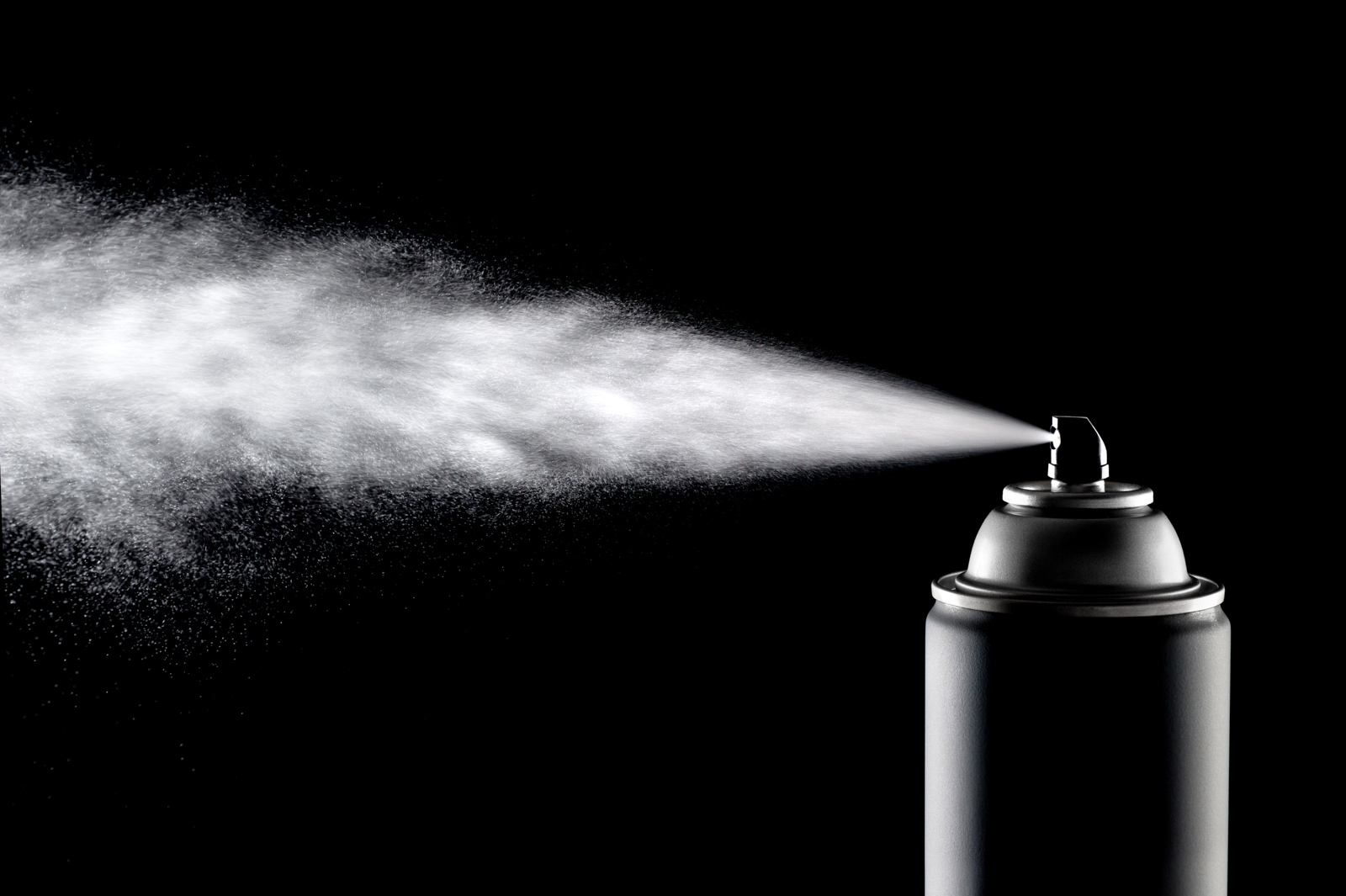 Macro image of spraying aerosol can in black and white