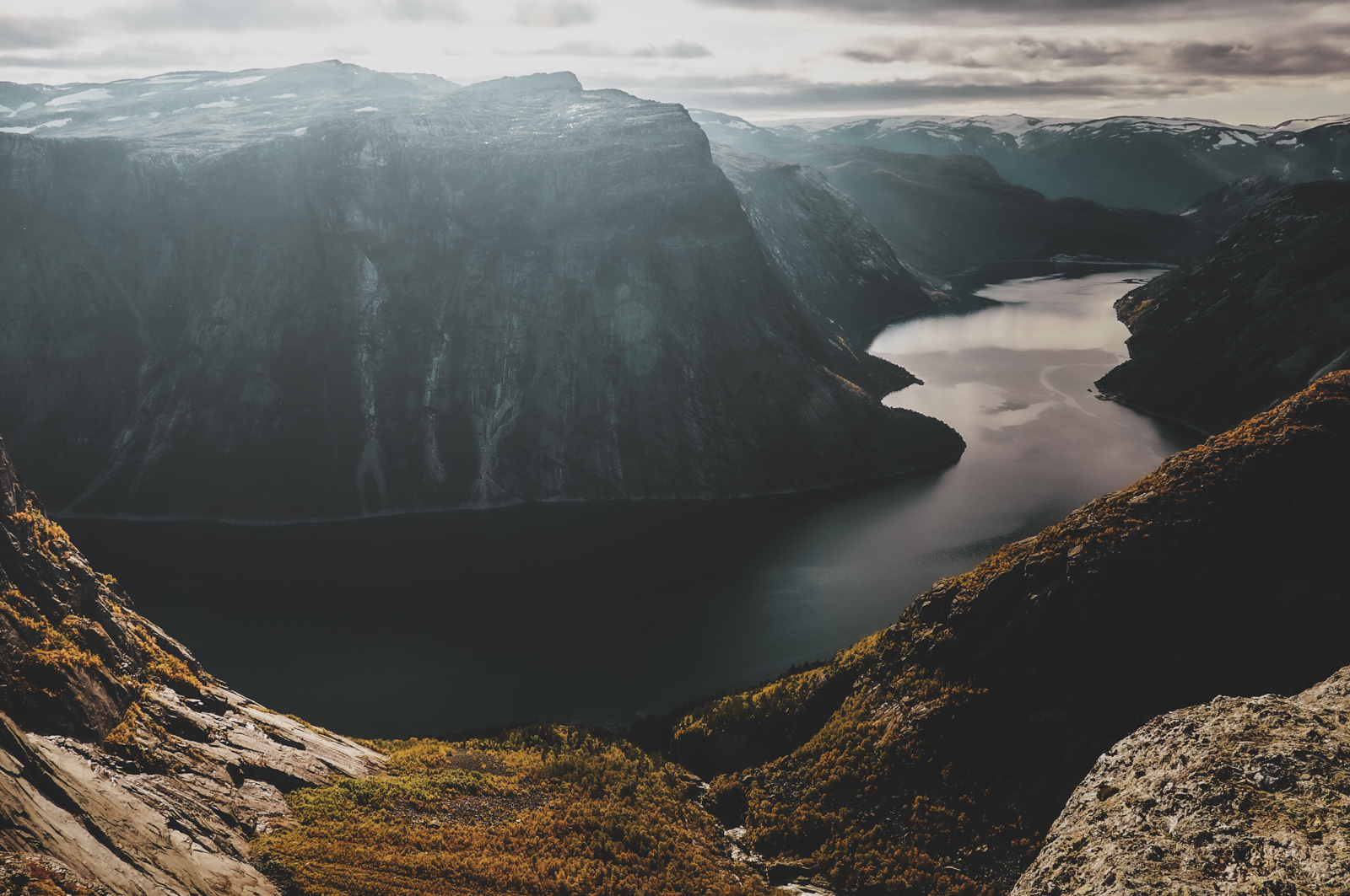 Fjord with steep mountain sides and water winding through the landscape