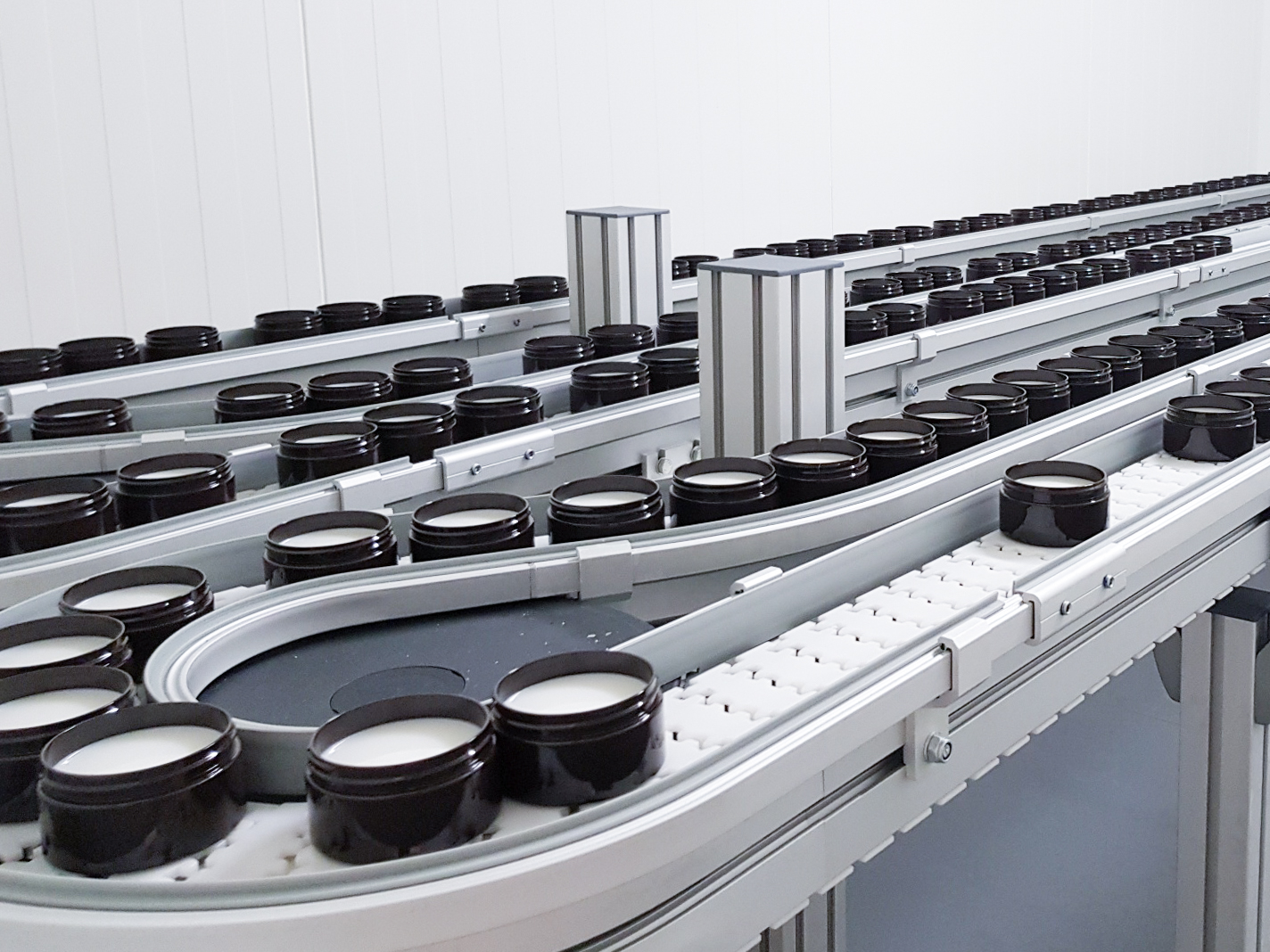 Jars moving through an automated production line in an industrial environment