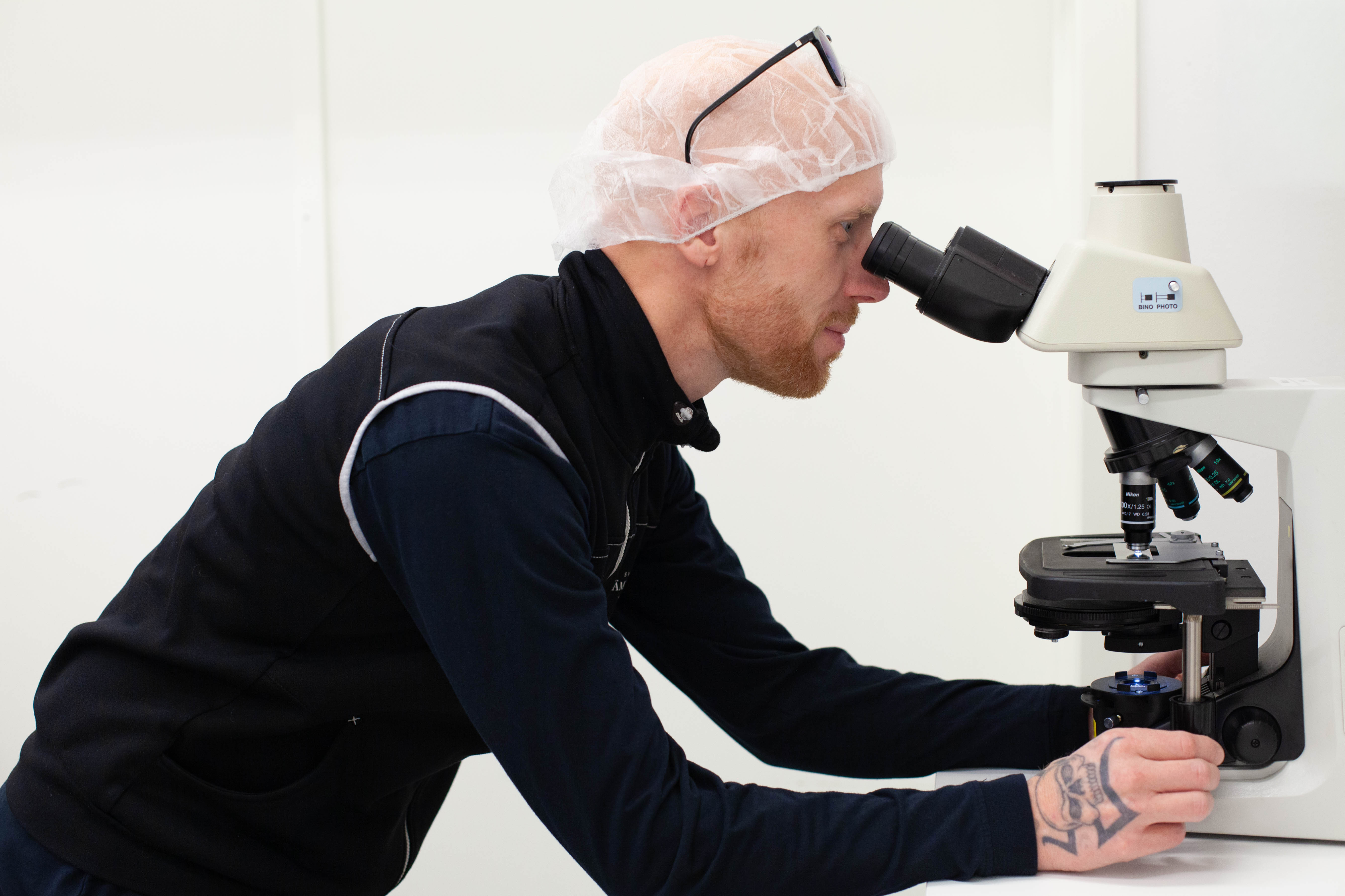 Man looking into a microscope